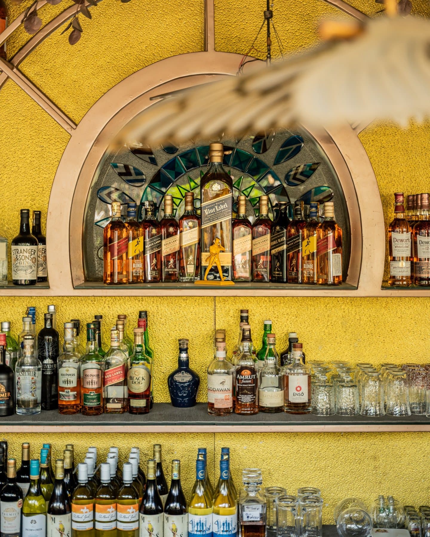 The amber-lit back bar stacked with spirits