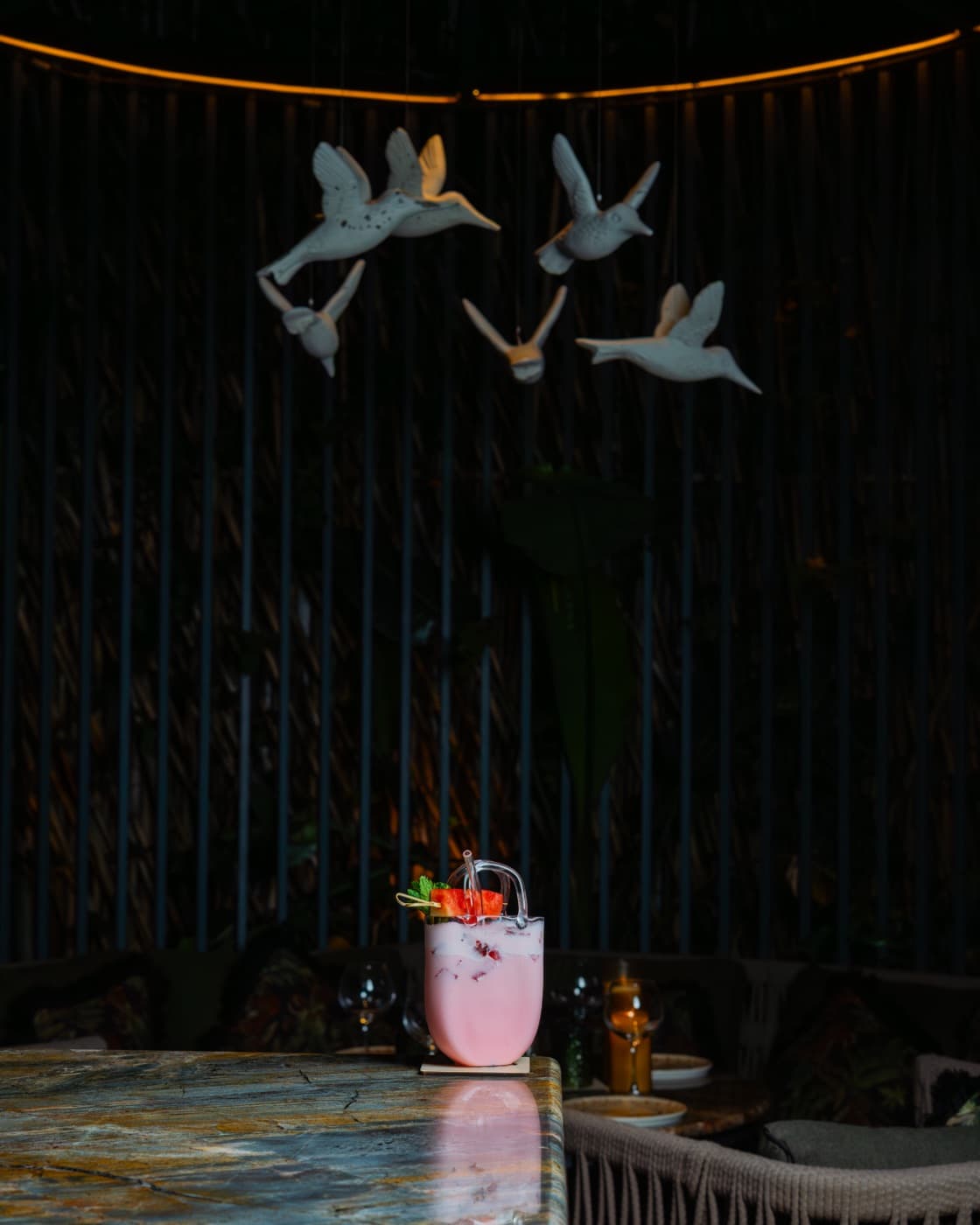 Sculpted birds in flight above a marble table