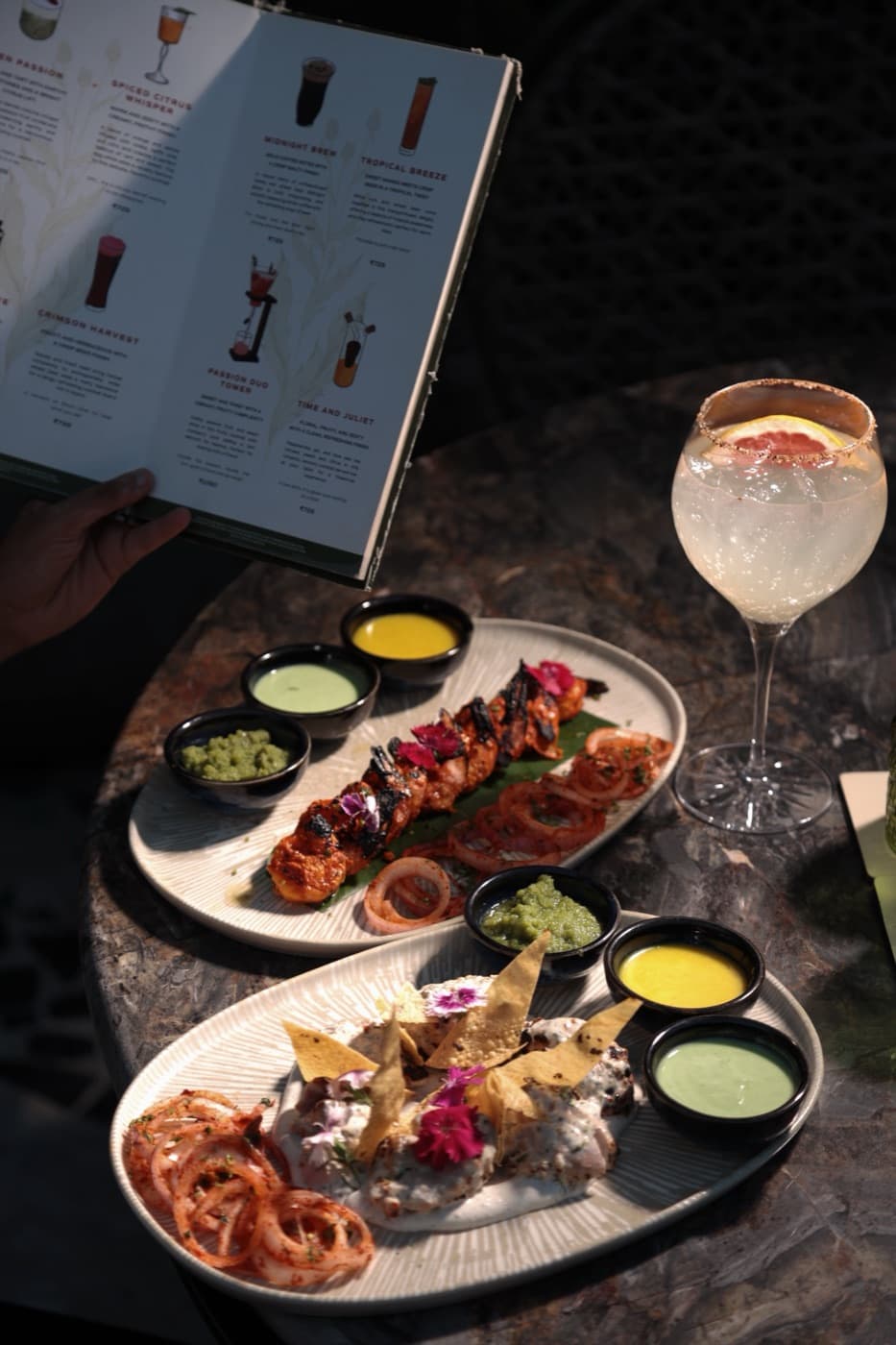Charcuterie platter beside the cocktail menu